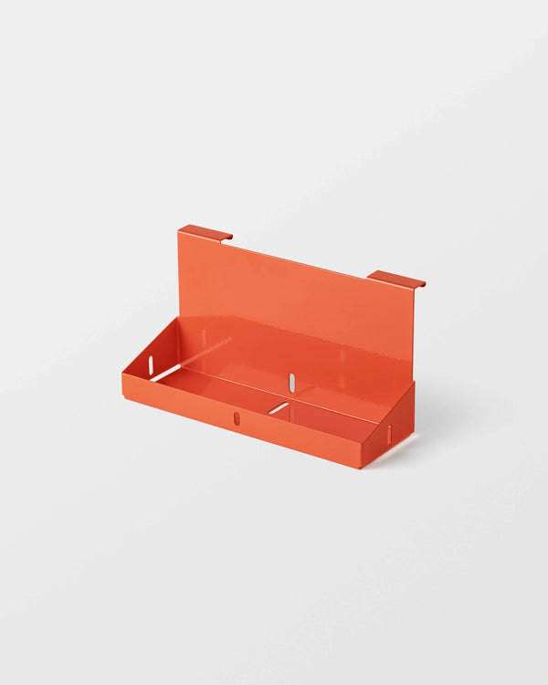 Orange wall-mounted shelf on a white background