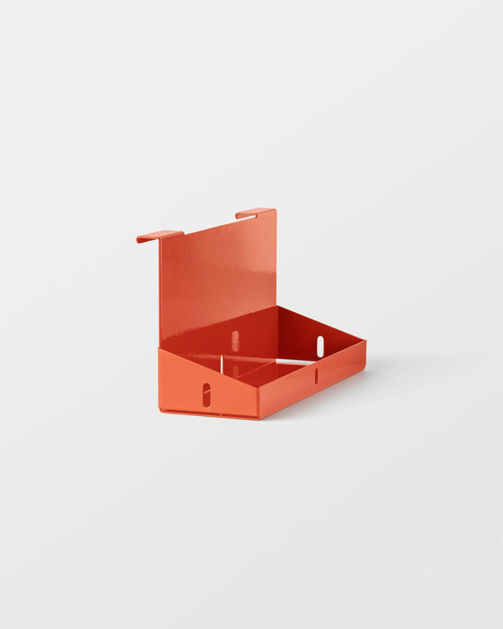 Orange wall-mounted storage shelf on a white background